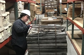Archive technician Kurstin McKinney inspects damage to some of the core housing and a rock core. Photo by Natalie Fields.